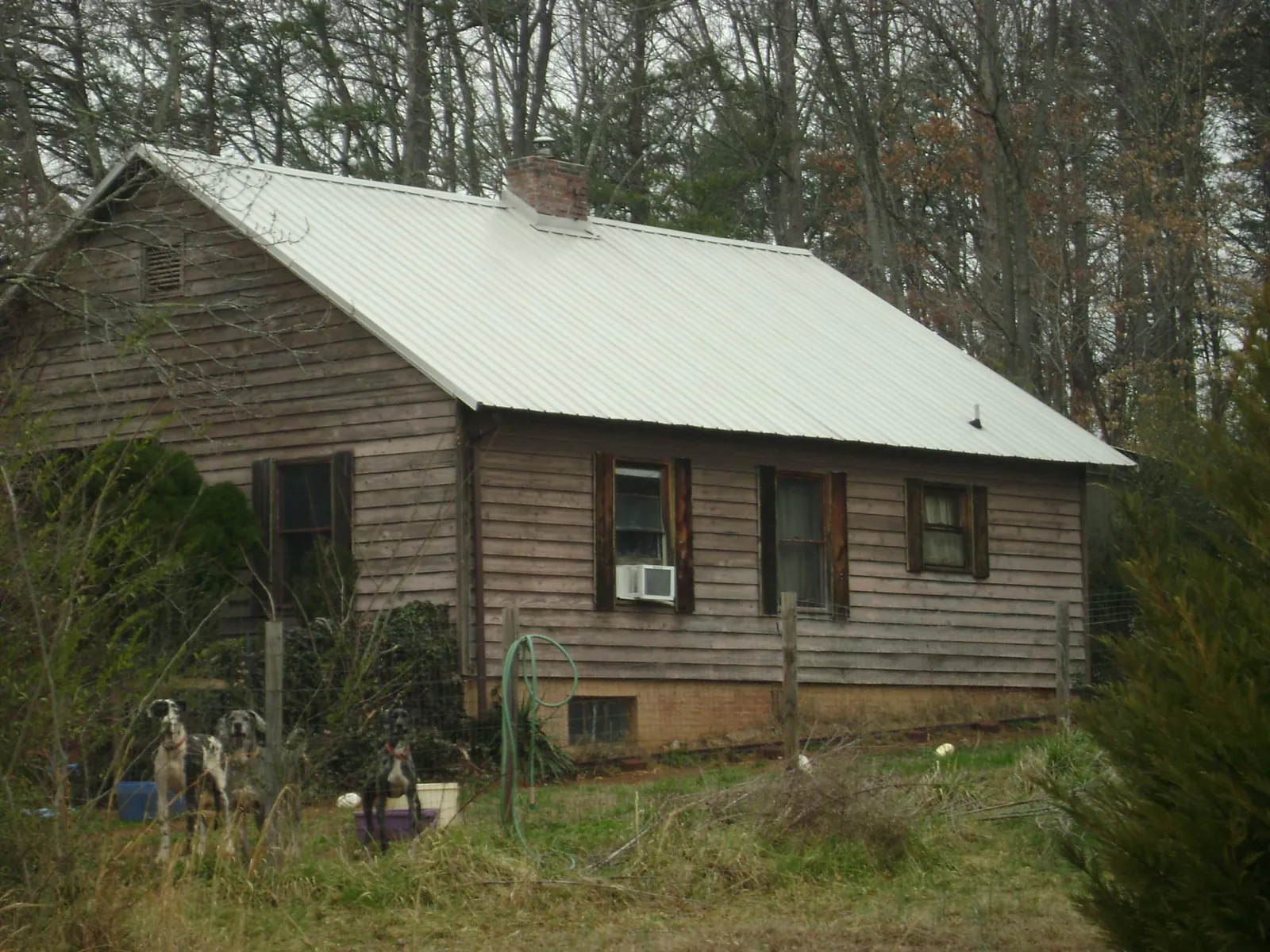 White metal roof on an old wood sided farmhouse, from a Metal Roof Installation job in Vernon Center