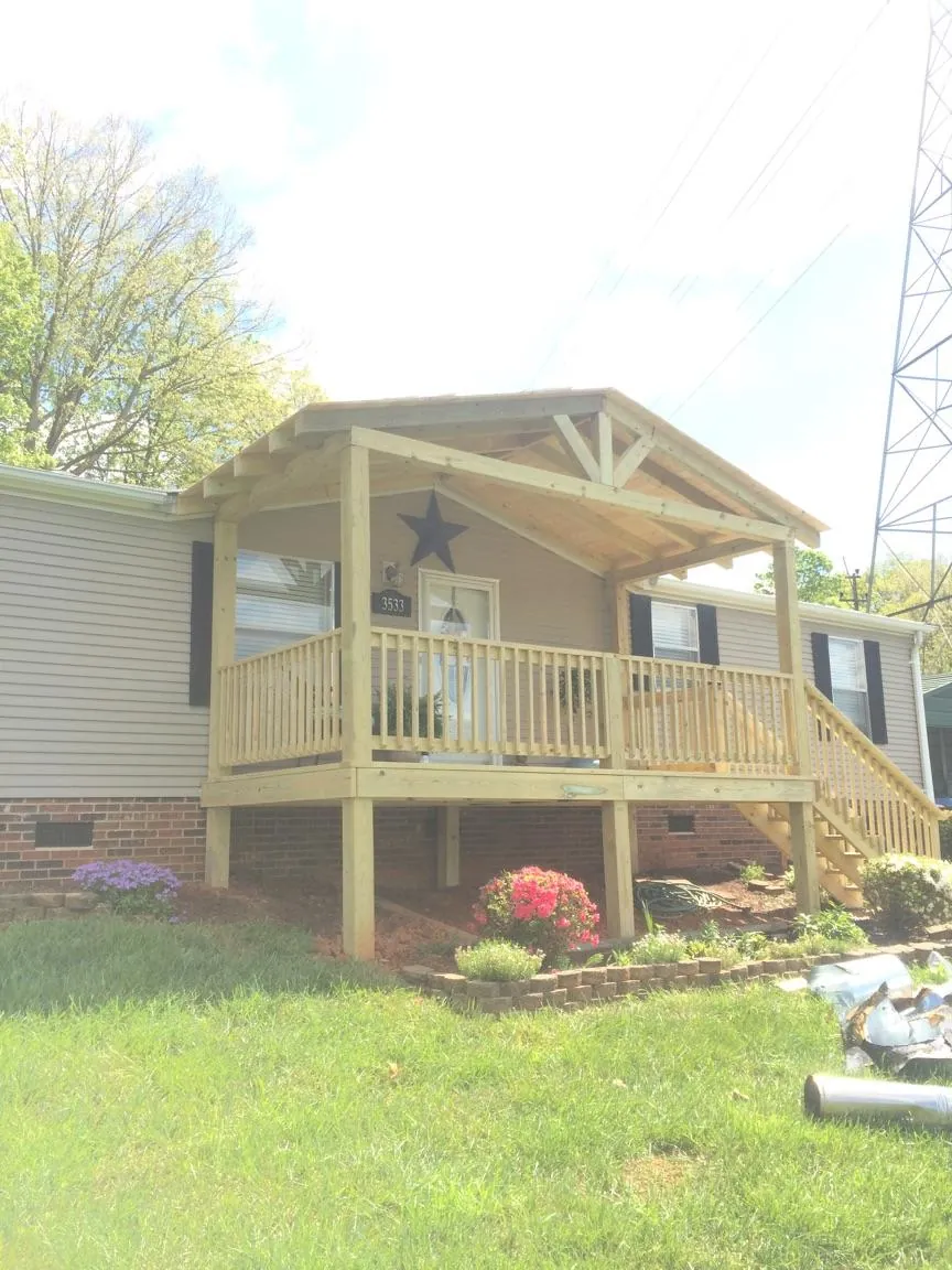 New gabled porch roof and deck railing added to a ranch home in Vernon Center